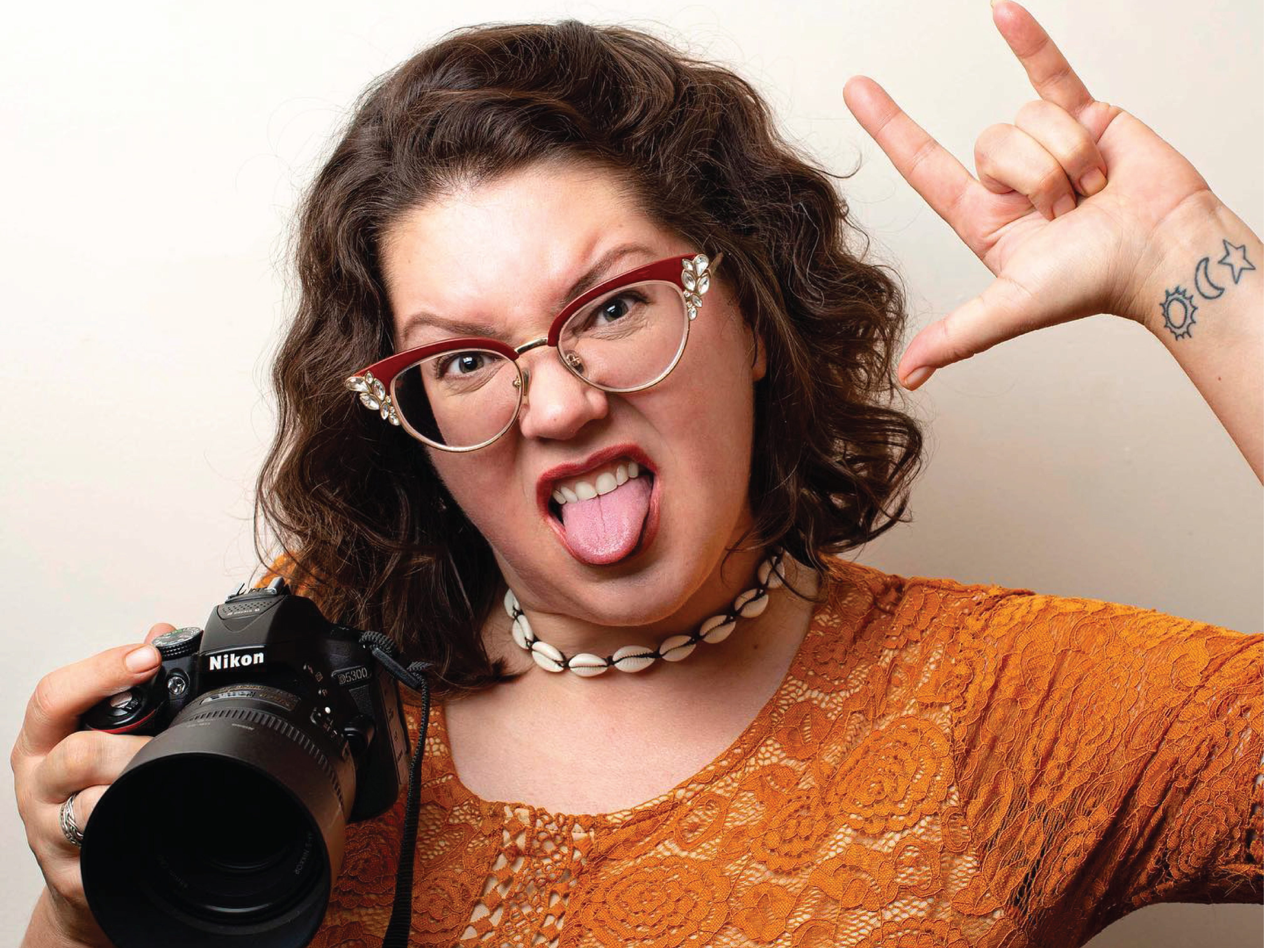 Photographer Sierra Rei Hart in a rock and roll pose with her tongue out