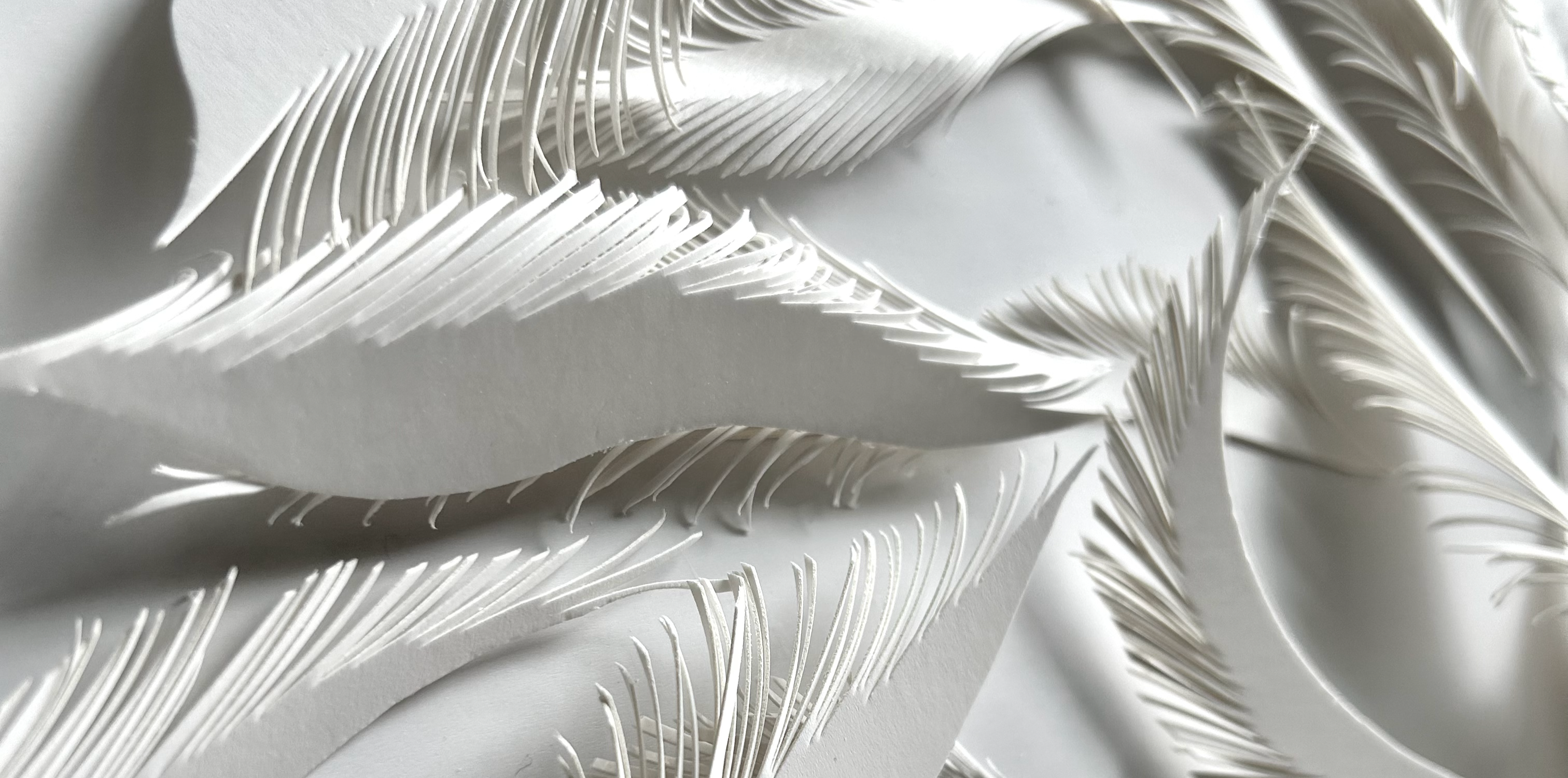 Image: Zhan Zhang, 11059 Cuts (detail), 2026; handcut Kraft paper, pins, projection 