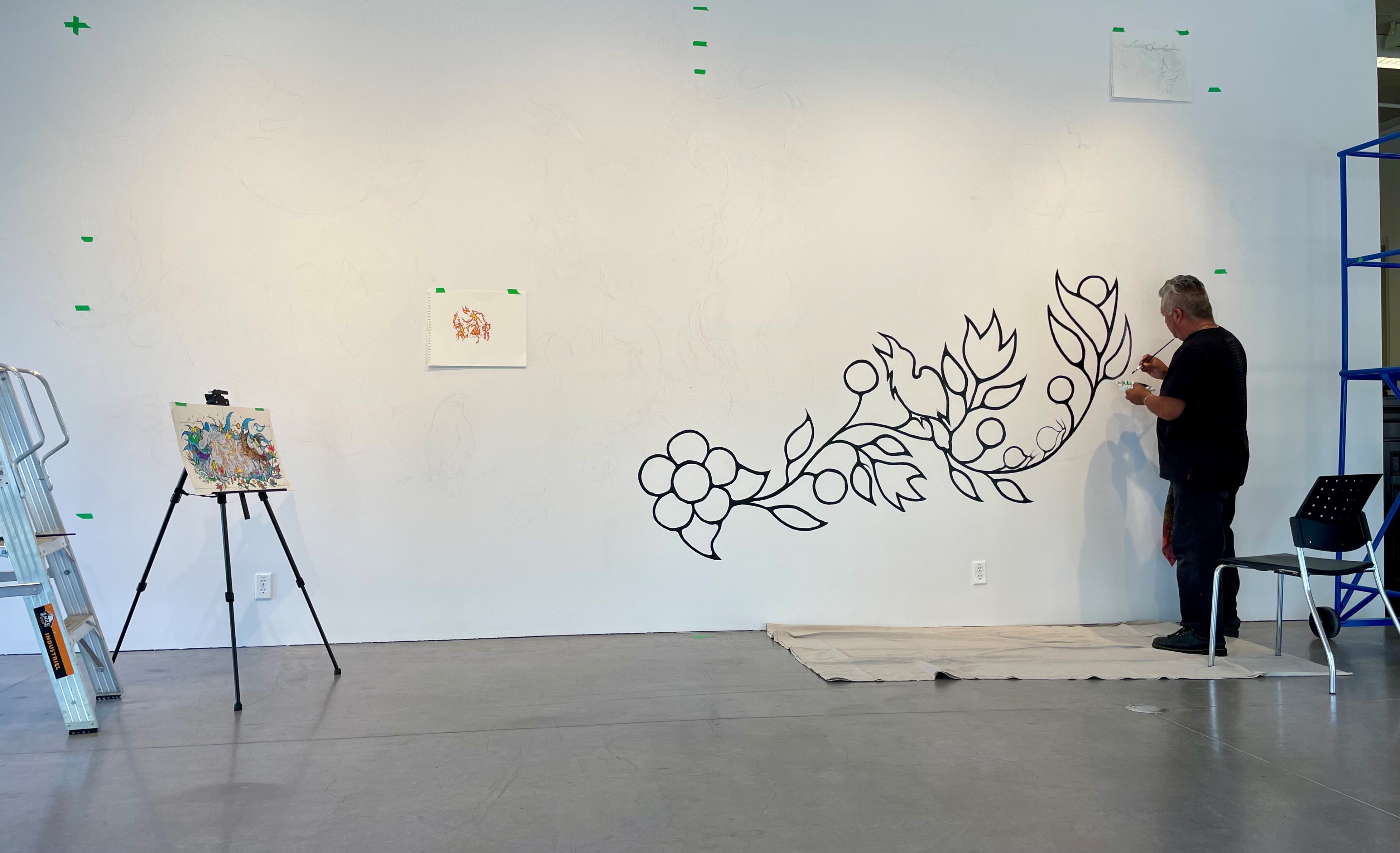 John Williams working on the mural in the lecture theatre at the Judith & Norman Alix Art Gallery.