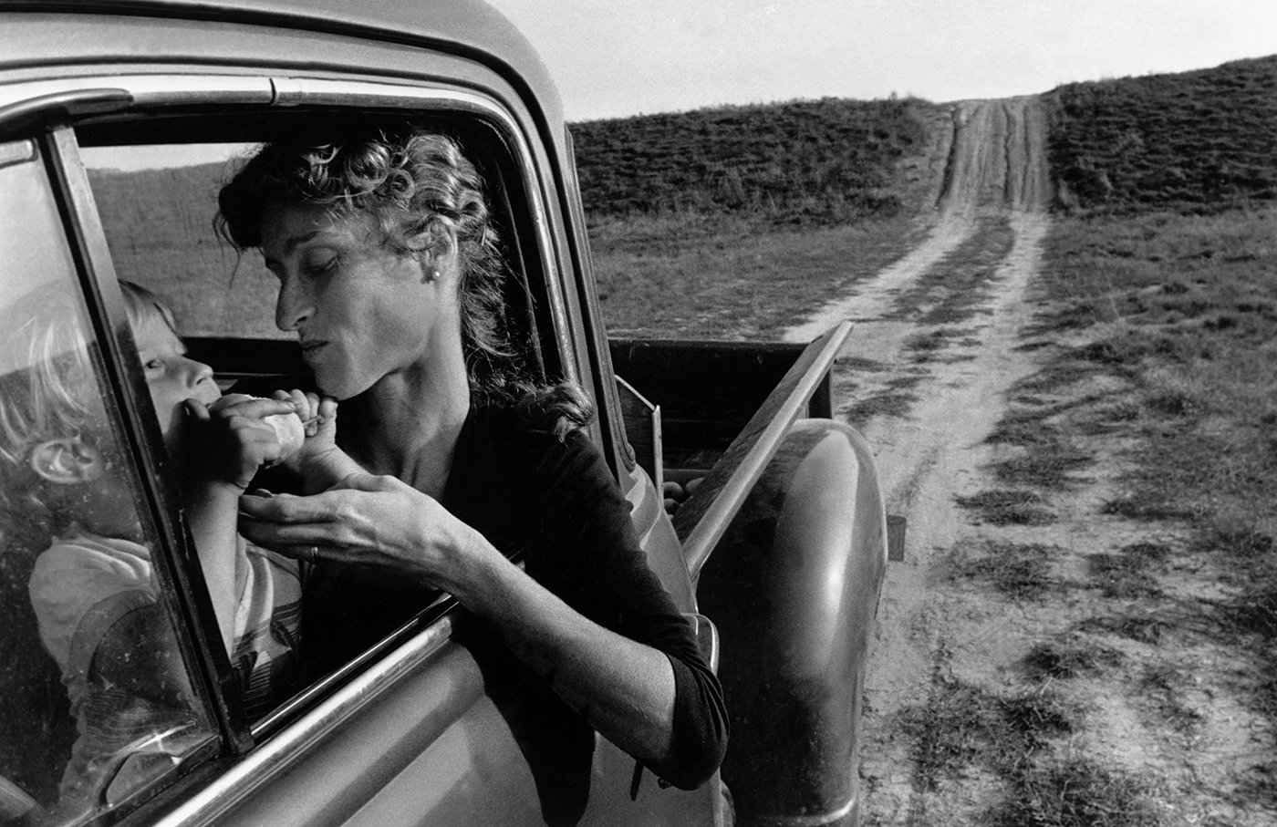 Woman and child sitting in a car - black and white photo