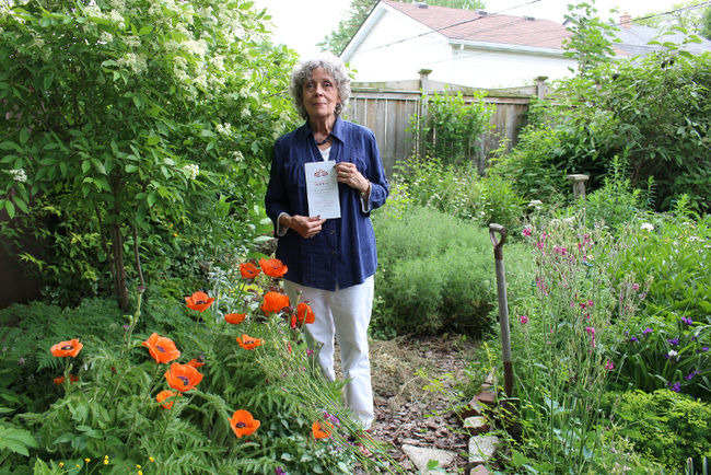 coordinator of the Communities in Bloom, Barbara Toye in a backyard garden.