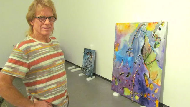 Sarnia artist Gary Nixon with his work.