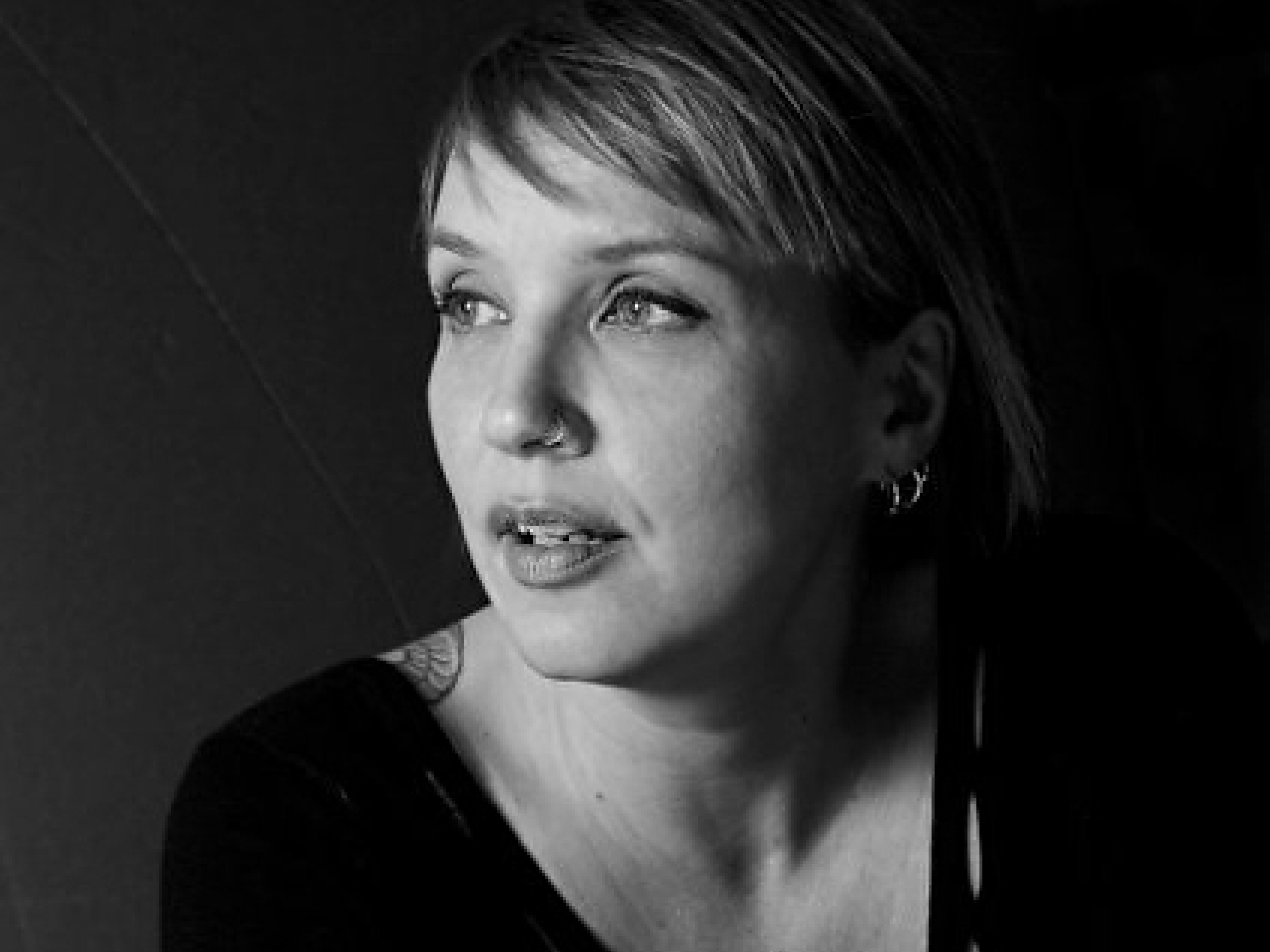 Black-and-white portrait of Liana Russwurm looking to the side against a dark background.