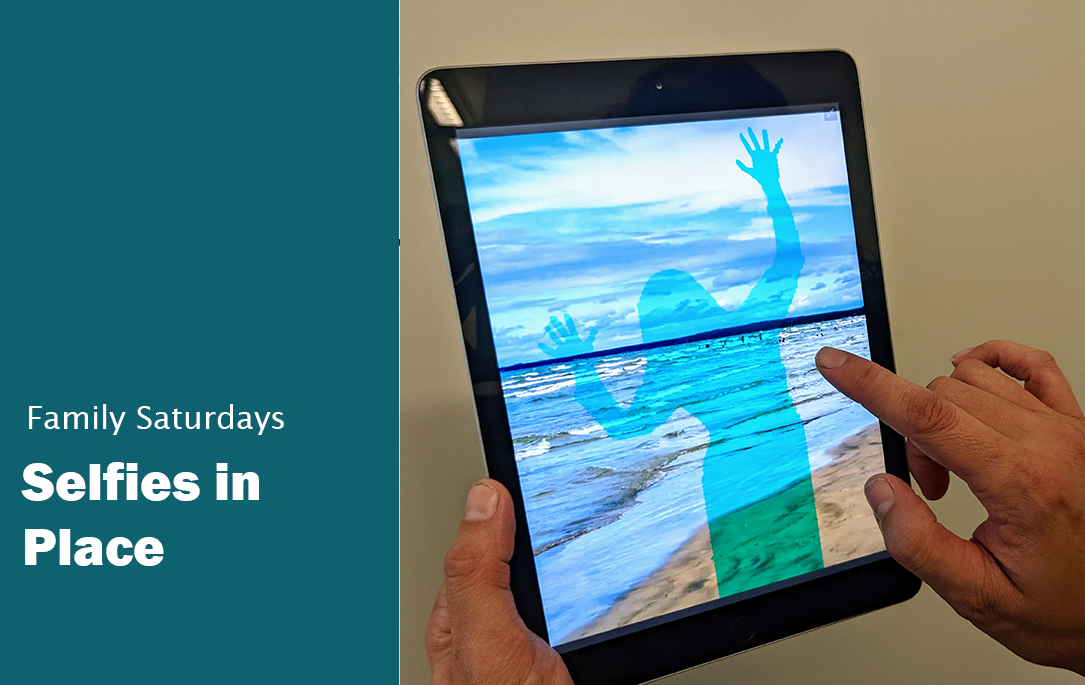 Text Family Saturdays Selfies in place. Image of a person holding up an ipad with a picture of a human silhouette on a beach