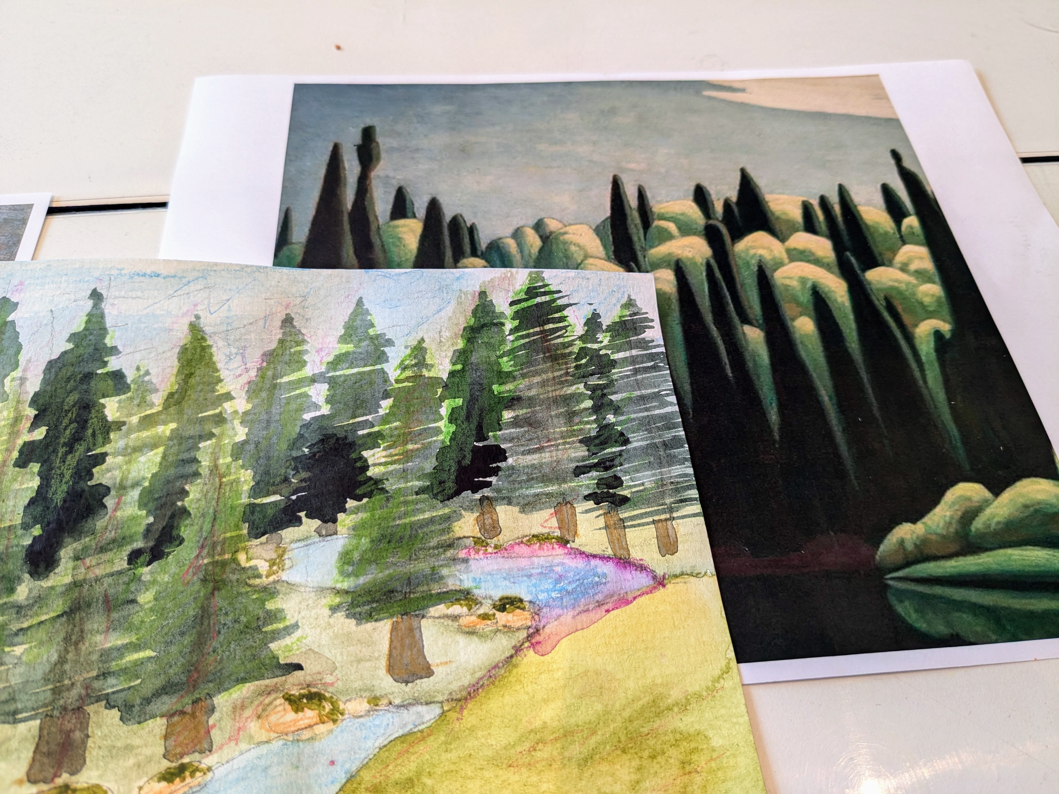 Two forest landscape artworks side by side, one a printed reference and one a watercolor study.