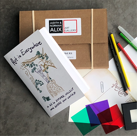 Pencil crayons, a brown paper package and a white card with the text that reads Art is Everywhere