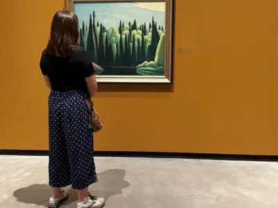 A-visitor-looks-at-Spring-on-the-Oxtongue-River-by-Group-of-Seven-artist-Lawren-Harris-currently-on-display-at-JNAAG.jpg