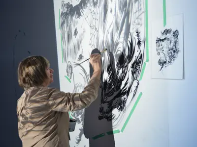 Kate Wilson working on her mural installation