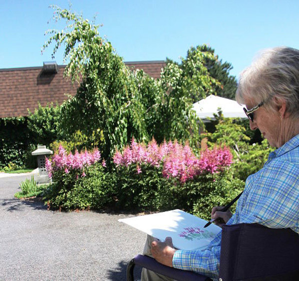 Artist Janet Morris paints the scene in the Japanese meditation garden at the entrance to Germain Park Saturday. She was one of eight artists painting in the Communities in Bloom Artists in the Garden Tour.